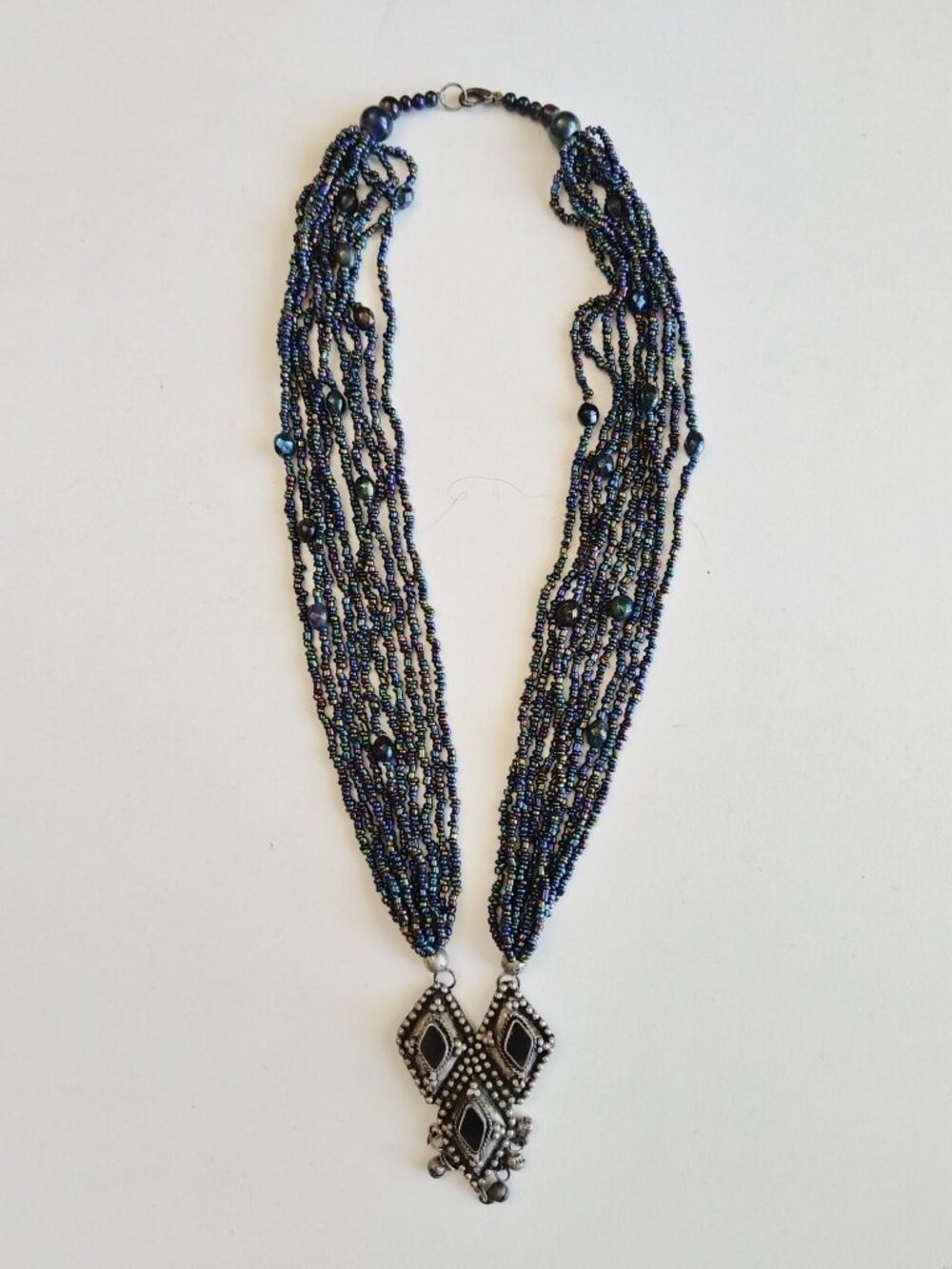 Vintage multi-strand beaded necklace with a distinctive ethnic tribal design.